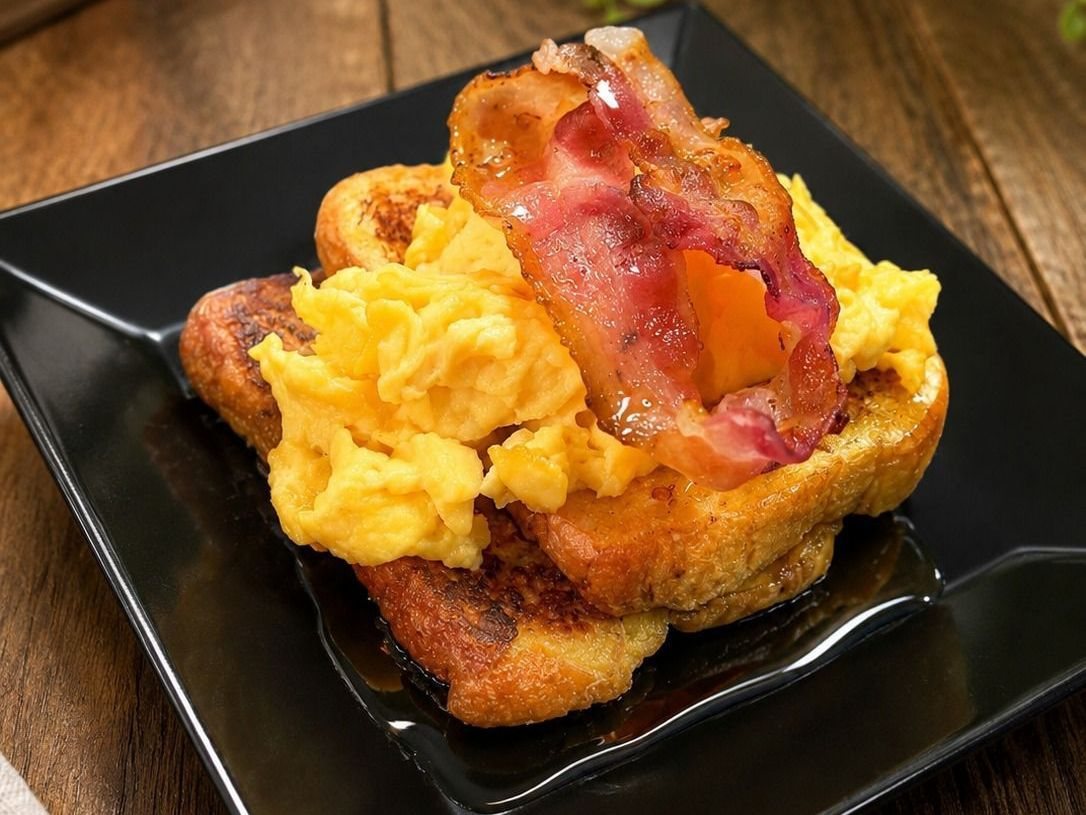 Brunch stack: french toast, scrambled eggs and bacon